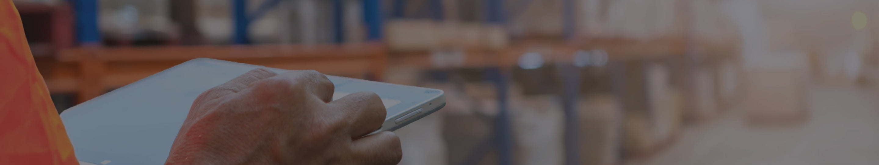 A Shopify Plus B2B and wholesale retailer using a tablet in a warehouse.