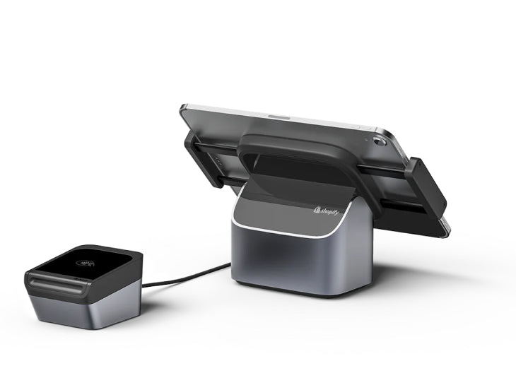 Shopify POS hardware setup with a sleek tablet stand, card reader, and receipt printer in a modern design, illustrating the point of sale system for retail.